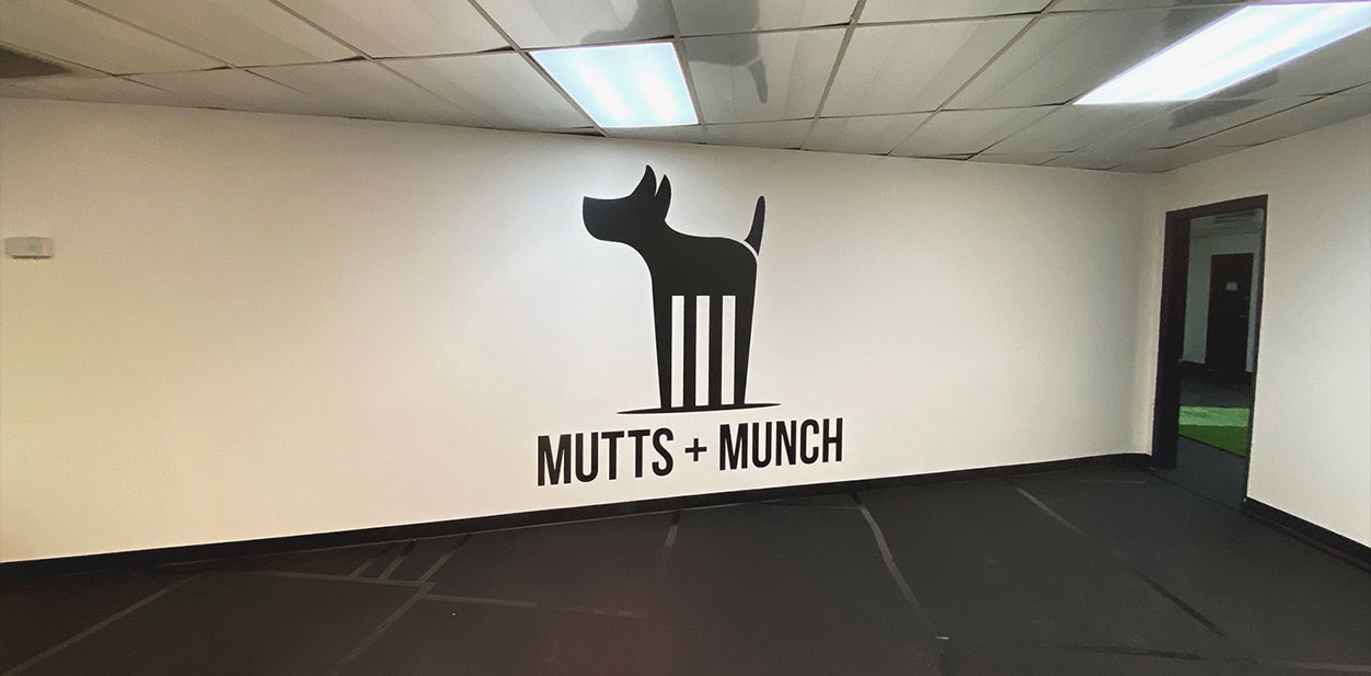 Mutts+Munch store branding design with a dog silhouette wall display