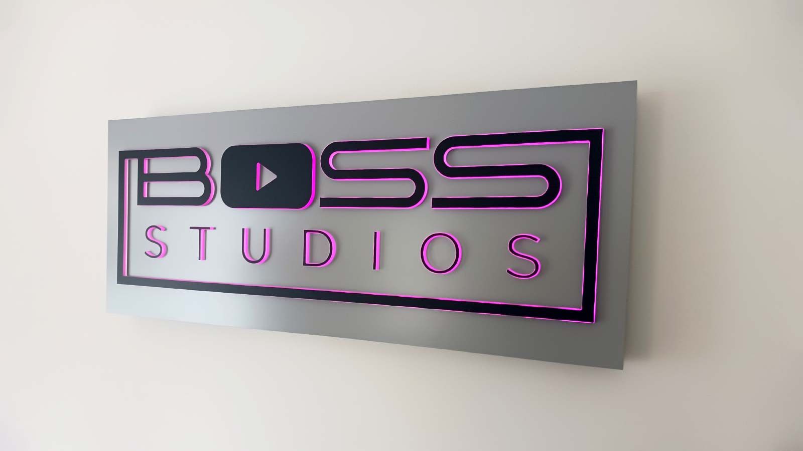 Boss Studios push through sign attached to the wall