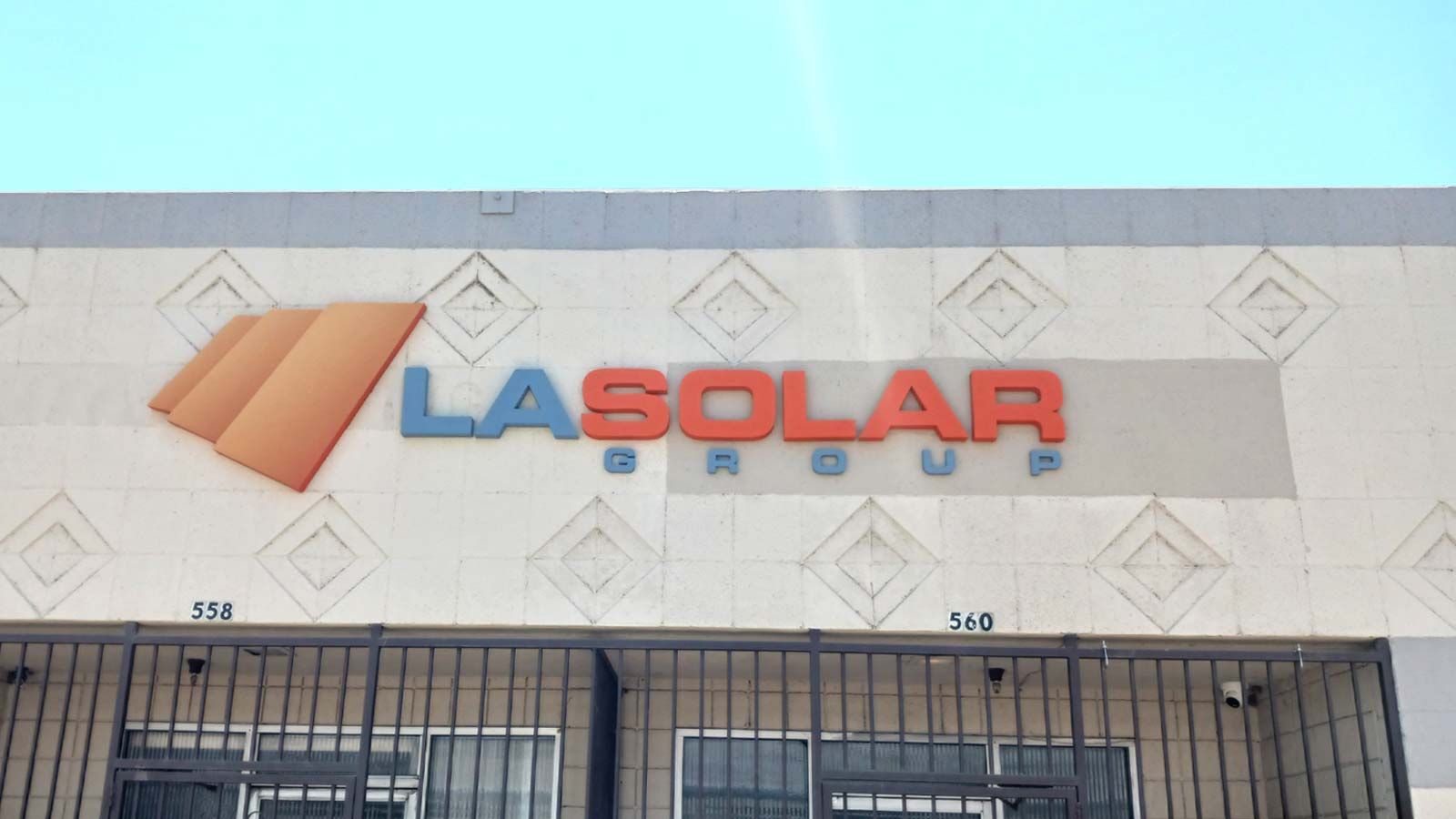 LA Solar Group outdoor sign installation on the facade