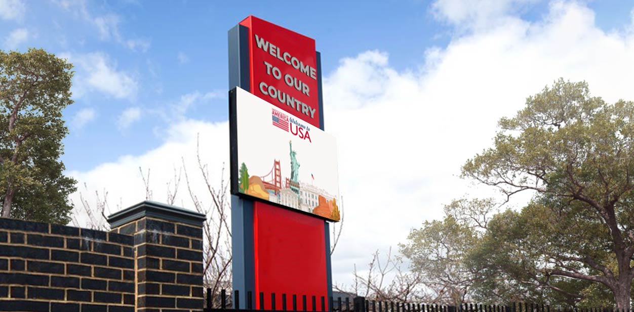 Massive place branding structure in red with a welcoming message