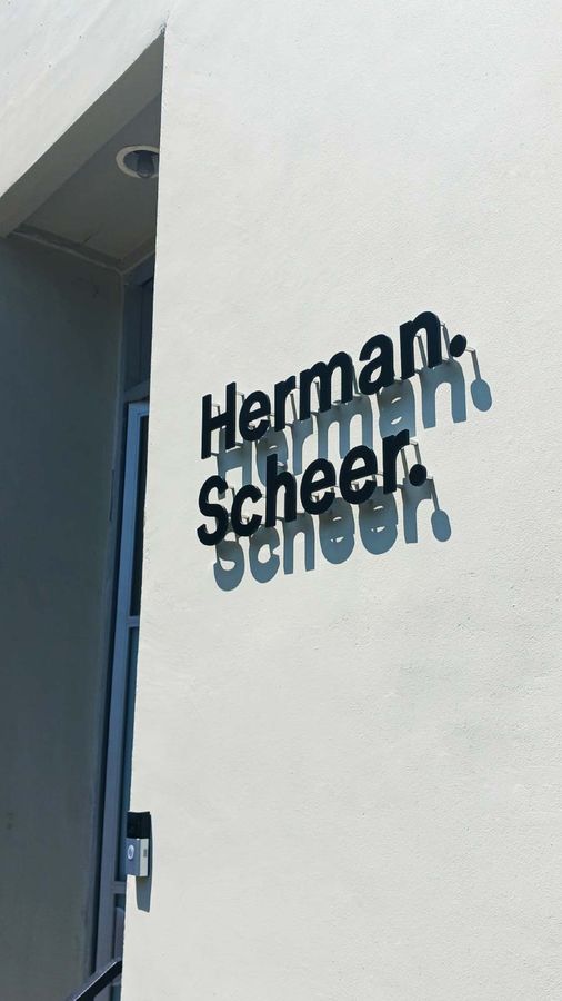 Herman-Scheer 3d letter pin mounted to the building