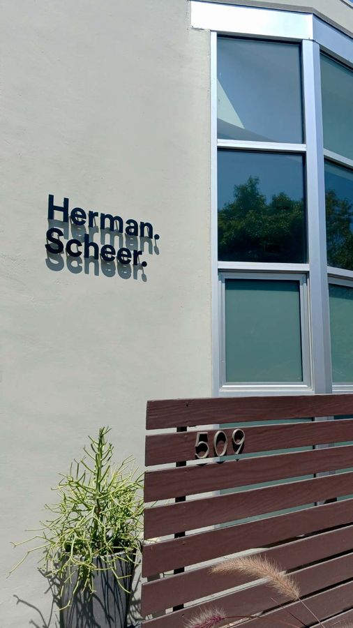 Herman-Scheer outdoor sign placed on the wall
