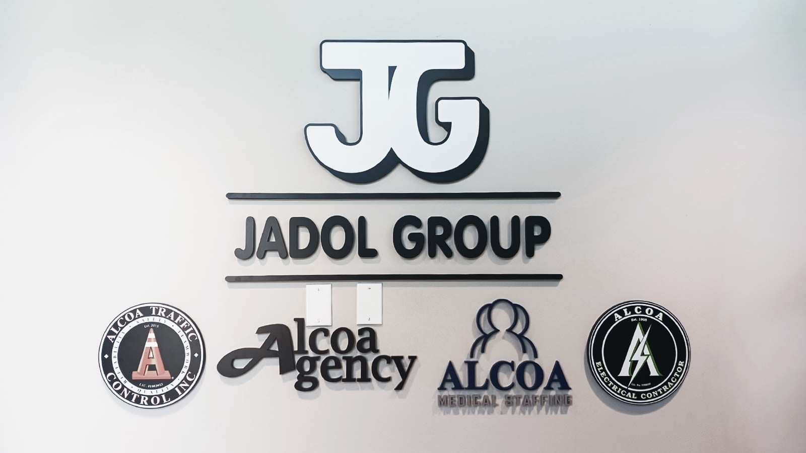 Jadol Group interior sign attached to the wall