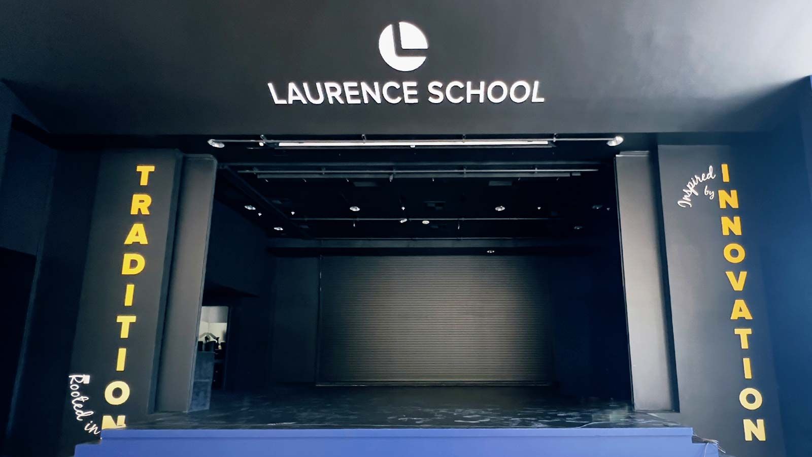 Laurence School college sign adhered to the interior wall