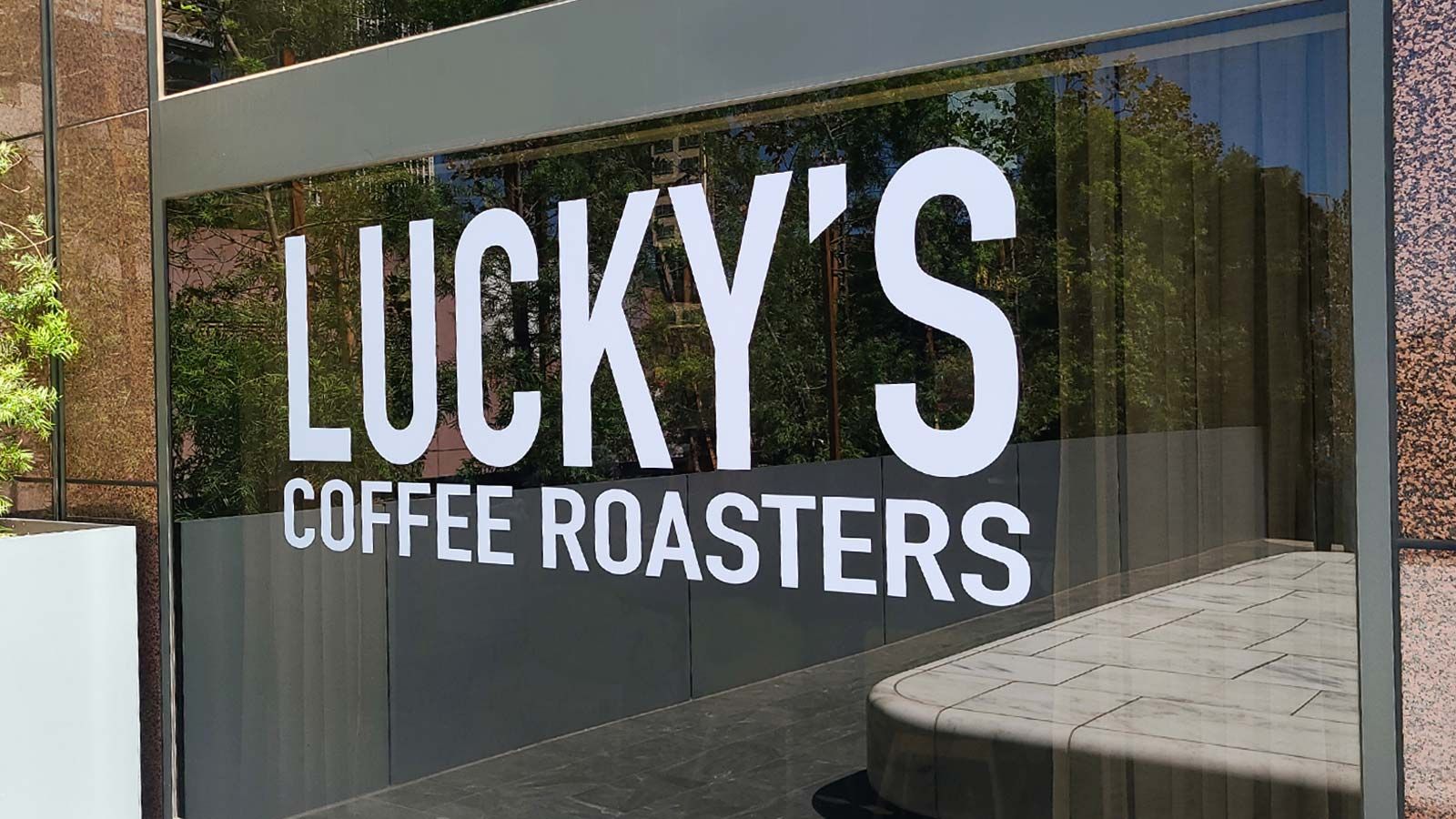 Lucky's Coffee Roasters vinyl lettering on the glass