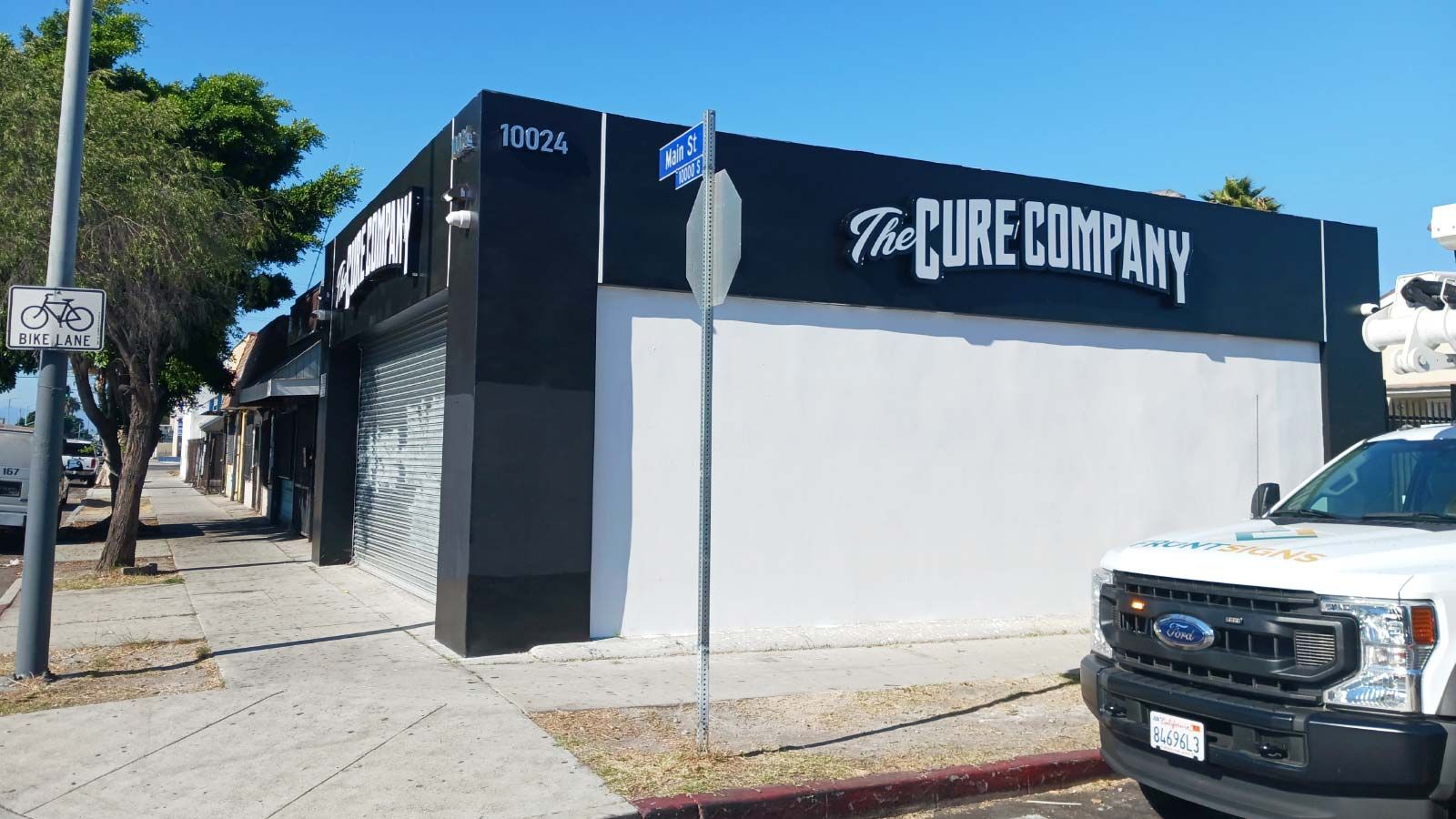 The Cure Company outdoor sign mounted to the building