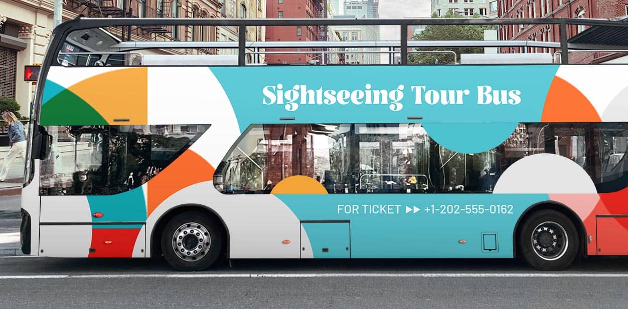 Colorful vehicle branding solutions on a white travel bus