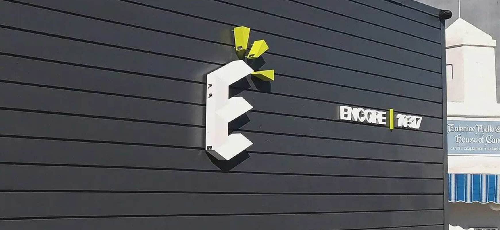 Encore logo sign in white and green made of lexan, aluminum and PVC for outdoor branding