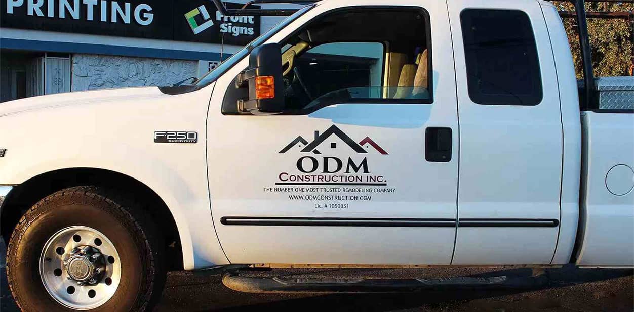 ODM Construction partial pickup truck branding with company's logo and website information