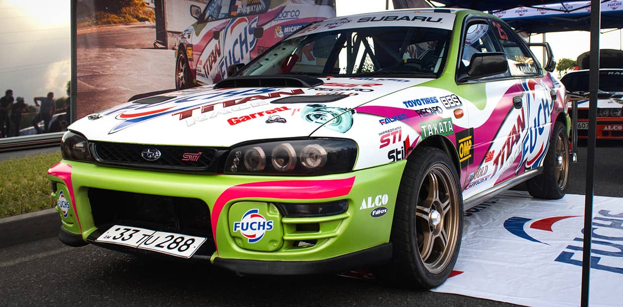 Colorful car branding displays fully covering a race car
