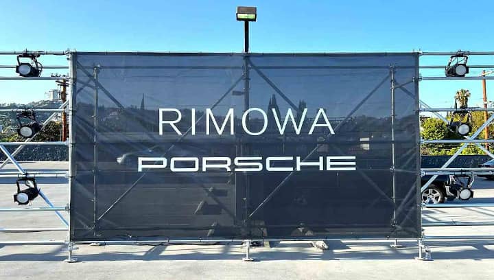 Rimowa Porche company logo sign in black made of mesh banner for outdoor event promotion