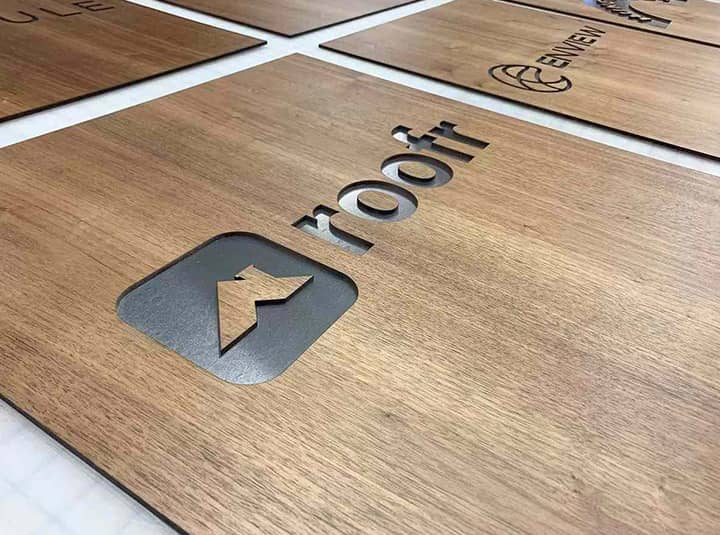 Roofr business logo sign in an engraved style made of wood