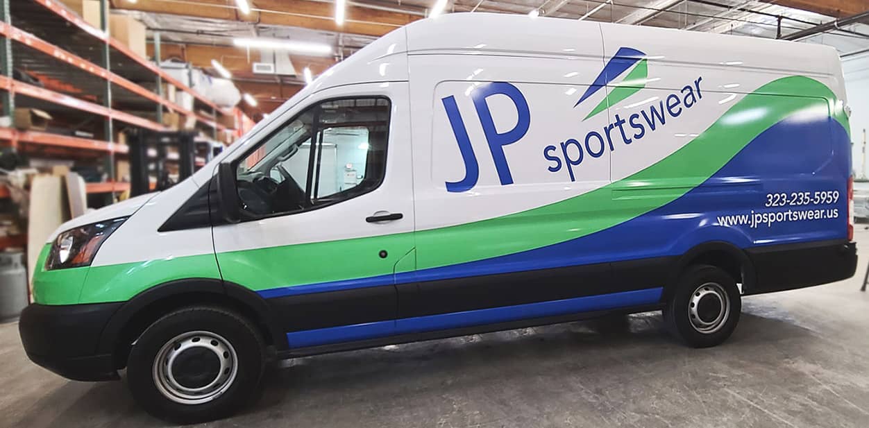 JP Sportswear vehicle branding solution in green and blue on a van