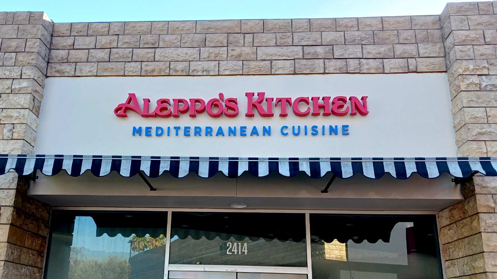 Aleppo's Kitchen backlit letters mounted on the wall