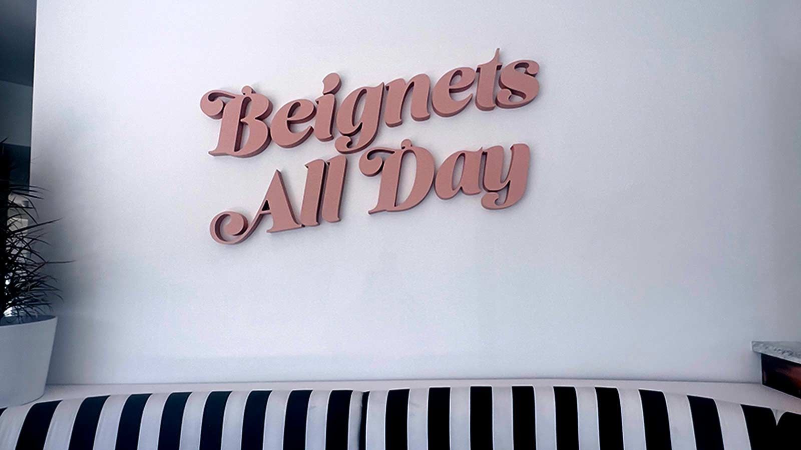 Beignets All Day foam core sign mounted on the wall