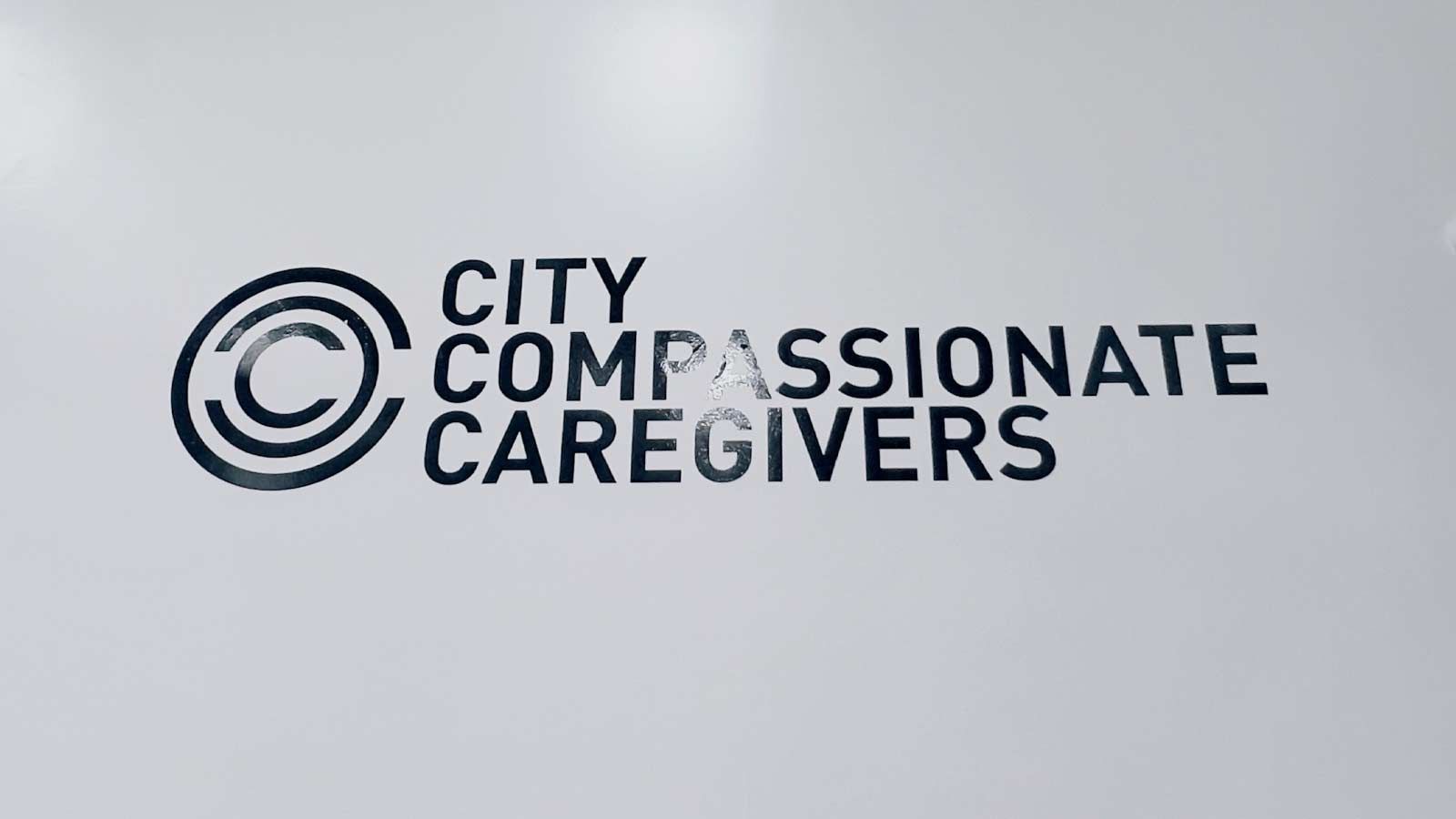 City Compassionate Caregivers vinyl lettering on the wall