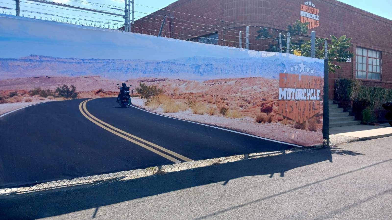 Explorify Motorcycle Rentals banner placed outdoors