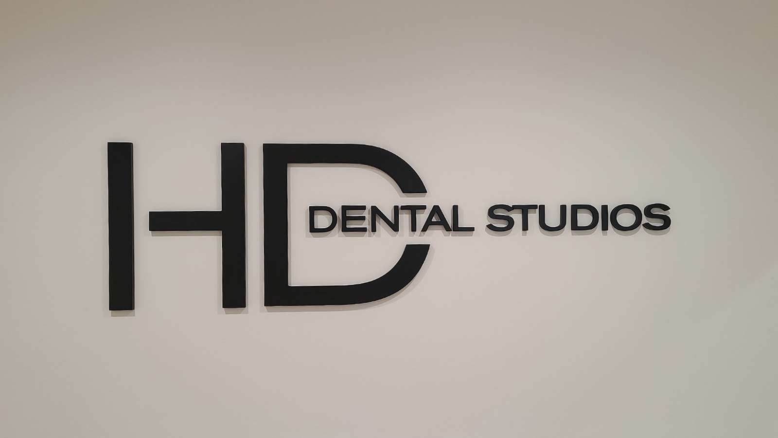 HD Dental Studios interior sign attached to the wall