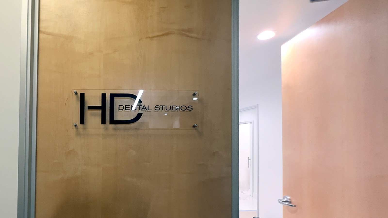 HD Dental Studios office sign attached to the wall