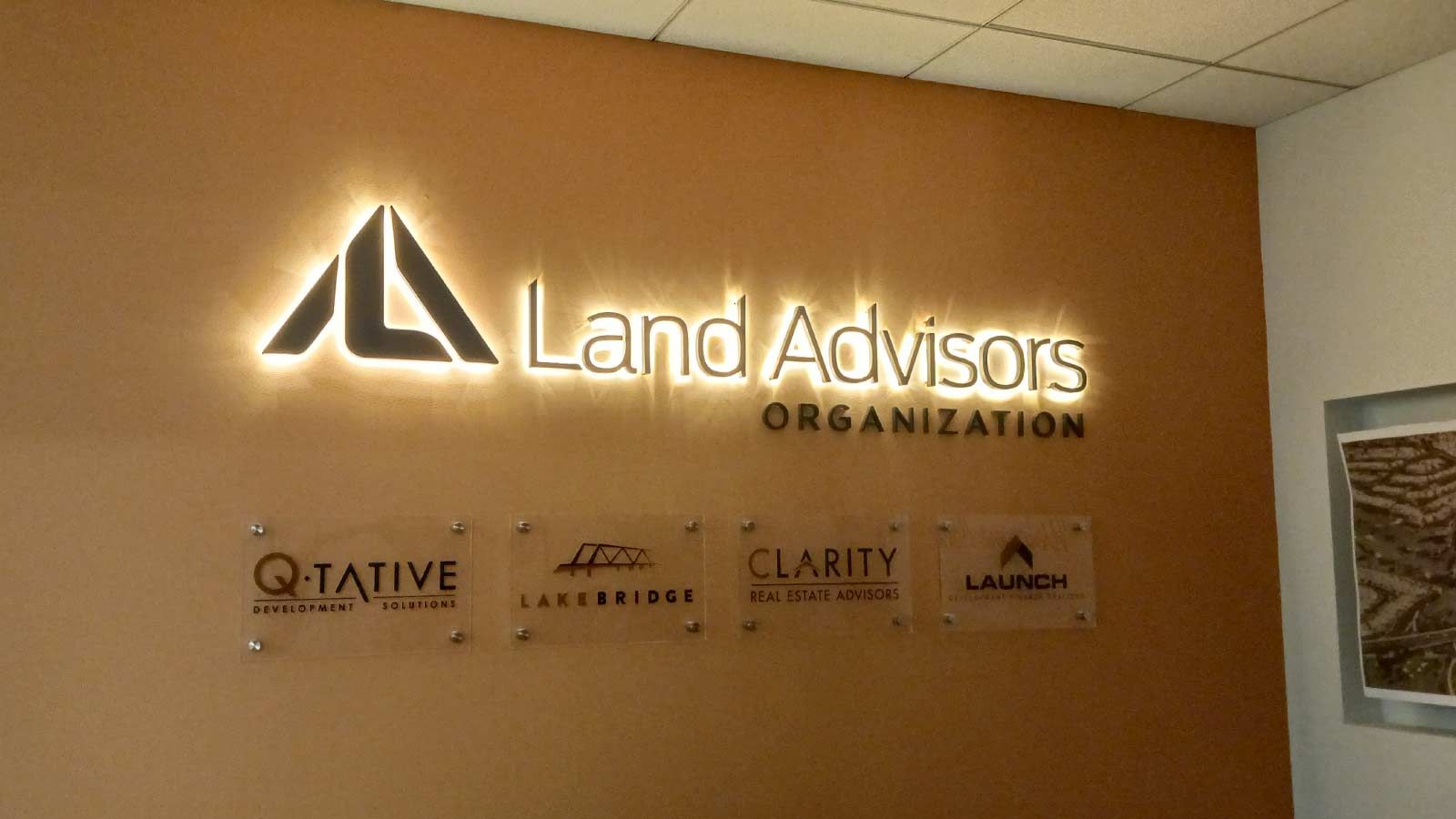 Land Advisors Organization backlit letters installed indoors