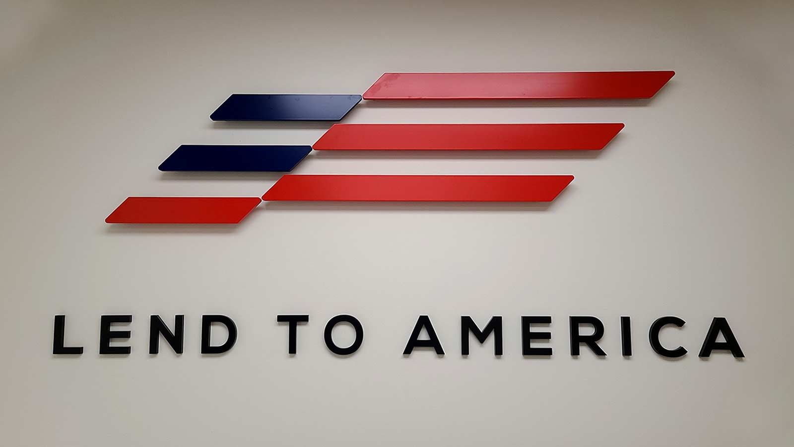 Lend to America office sign mounted on the wall