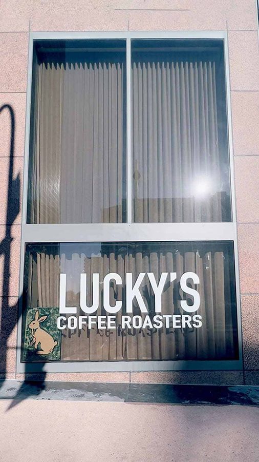 Lucky's Coffee Roasters vinyl letters attached to the window