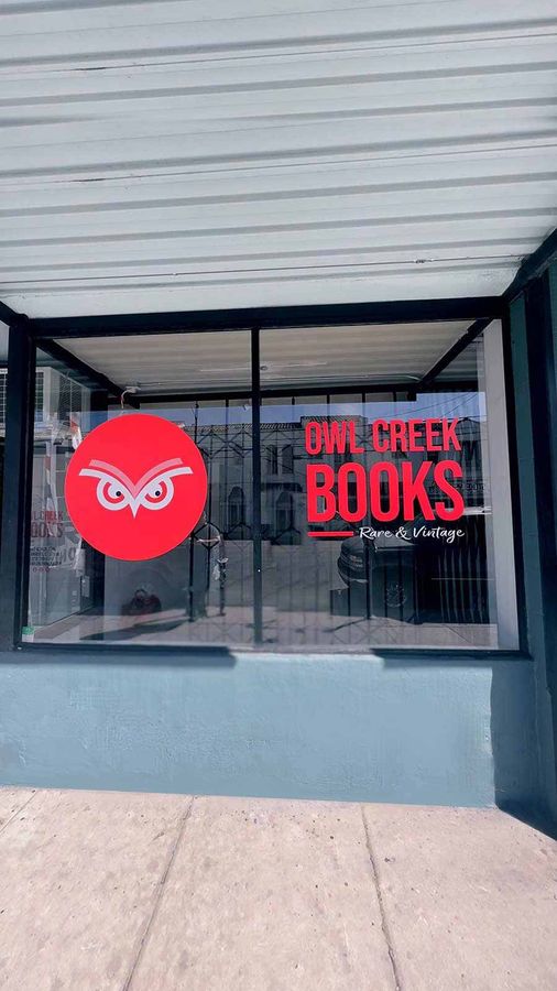 Owl Creek Books window decals attached to the storefront
