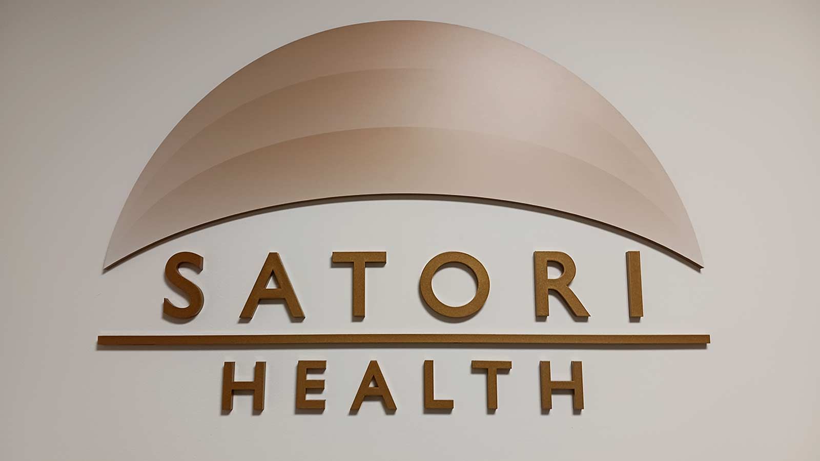 Satori Health 3D sign attached to the wall