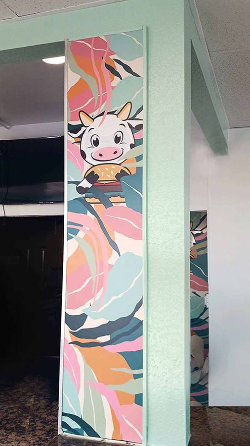 Spotless Burgers interior sign attached to the wall