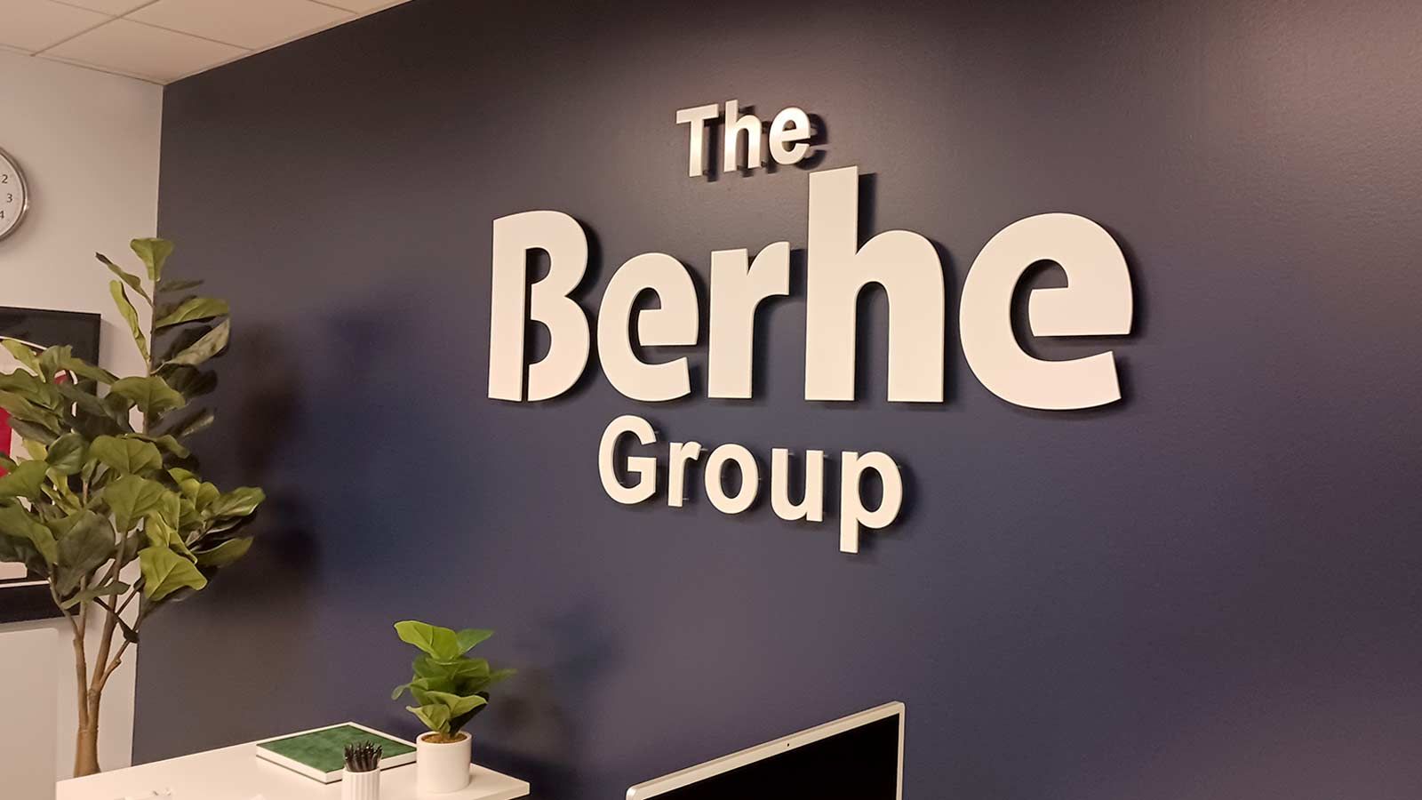 The Berhe Group interior sign mounted on the wall
