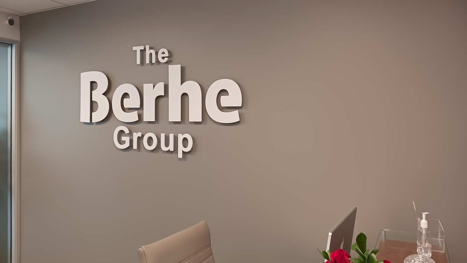 The Berhe Group office sign mounted on the wall