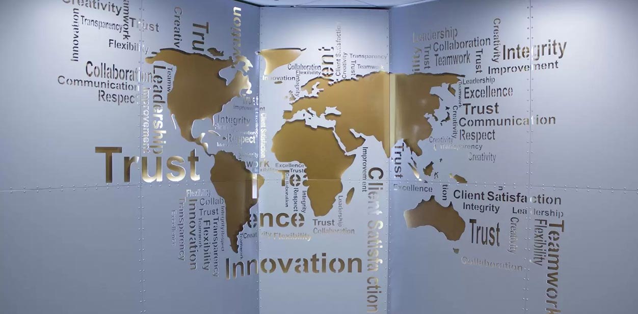 Aluminum feature wall with engraved world map and company value displays