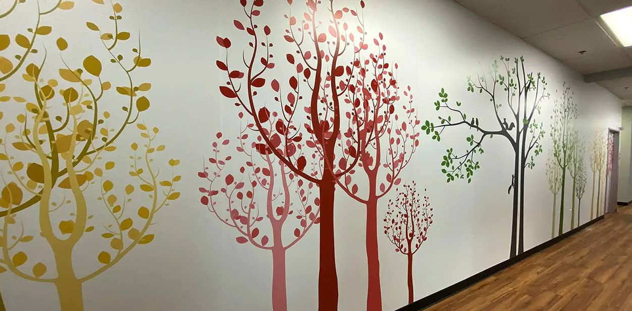 Art feature wall mural with colorful trees in different sizes for hallway decoration