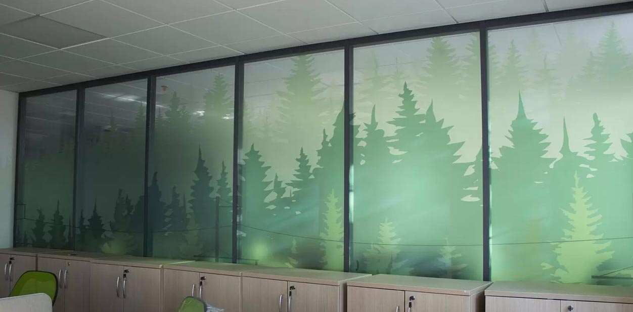 Decorative glass feature wall displaying a bunch of fir trees for interior design