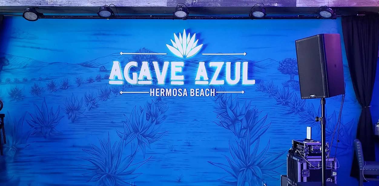 Agave Azul LED feature wall displaying the company's name and logo on a panoramic background