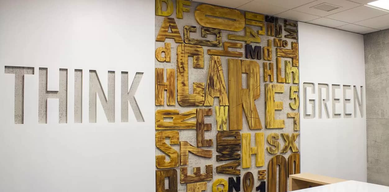 Custom feature wall with cut-out letters and the text Think Green engraved on it