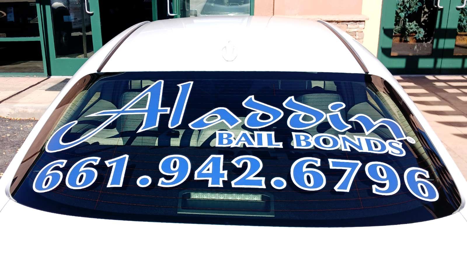 Aladdin Bail Bonds vinyl lettering for a rear windshield