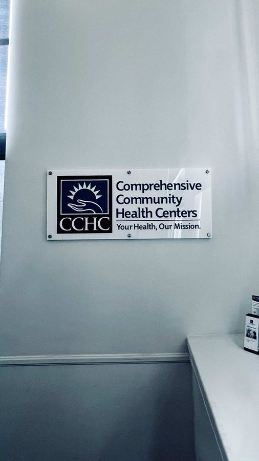 Comprehensive Community Health Centers lobby sign on a wall