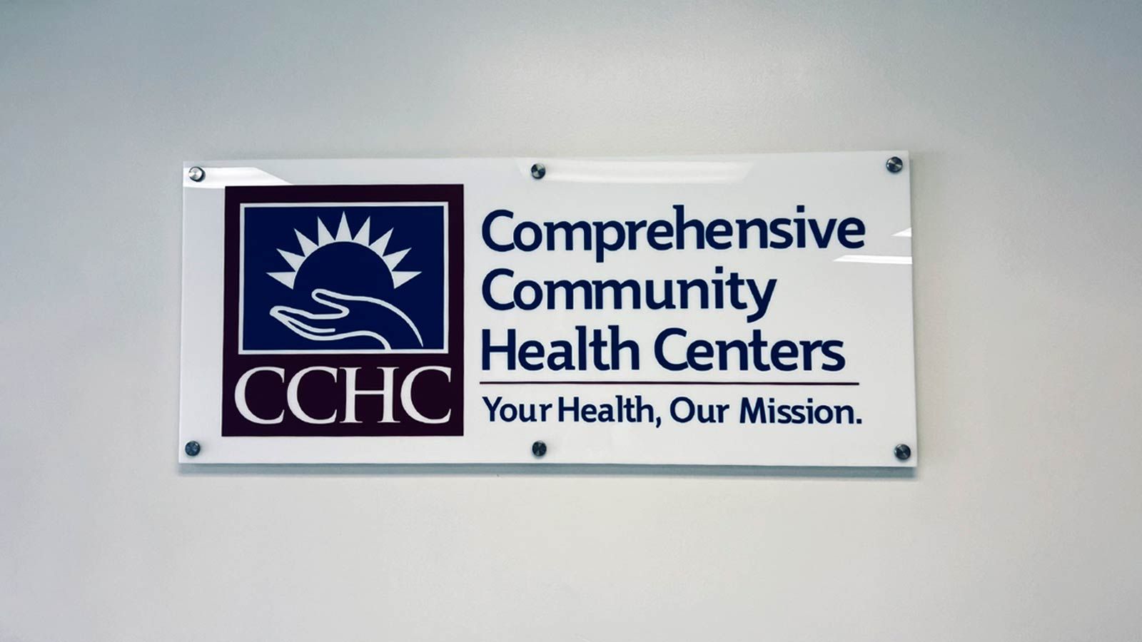 Comprehensive Community Health Centers office sign on a wall