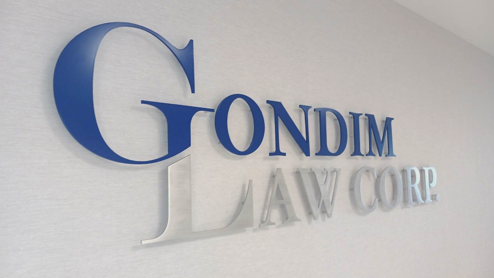 Gondim Law Corp aluminum sign attached to the wall