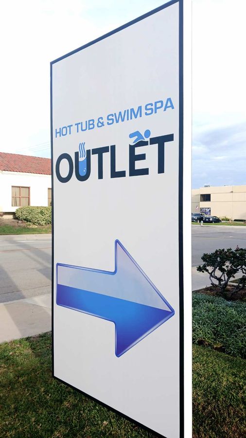 Hot Tub and Swim Spa Outlet outdoor sign set up on the lawn