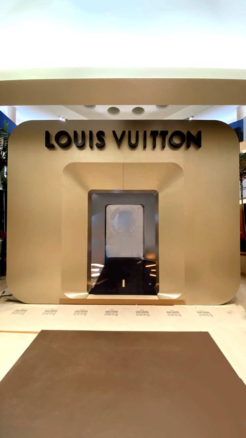 Louis Vuitton light up sign mounted indoors