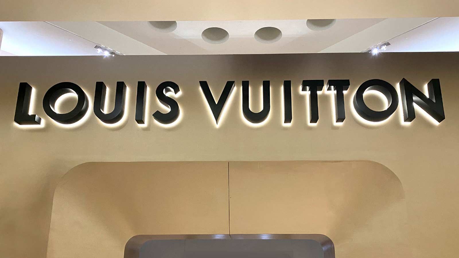 Louis Vuitton logo sign attached indoors