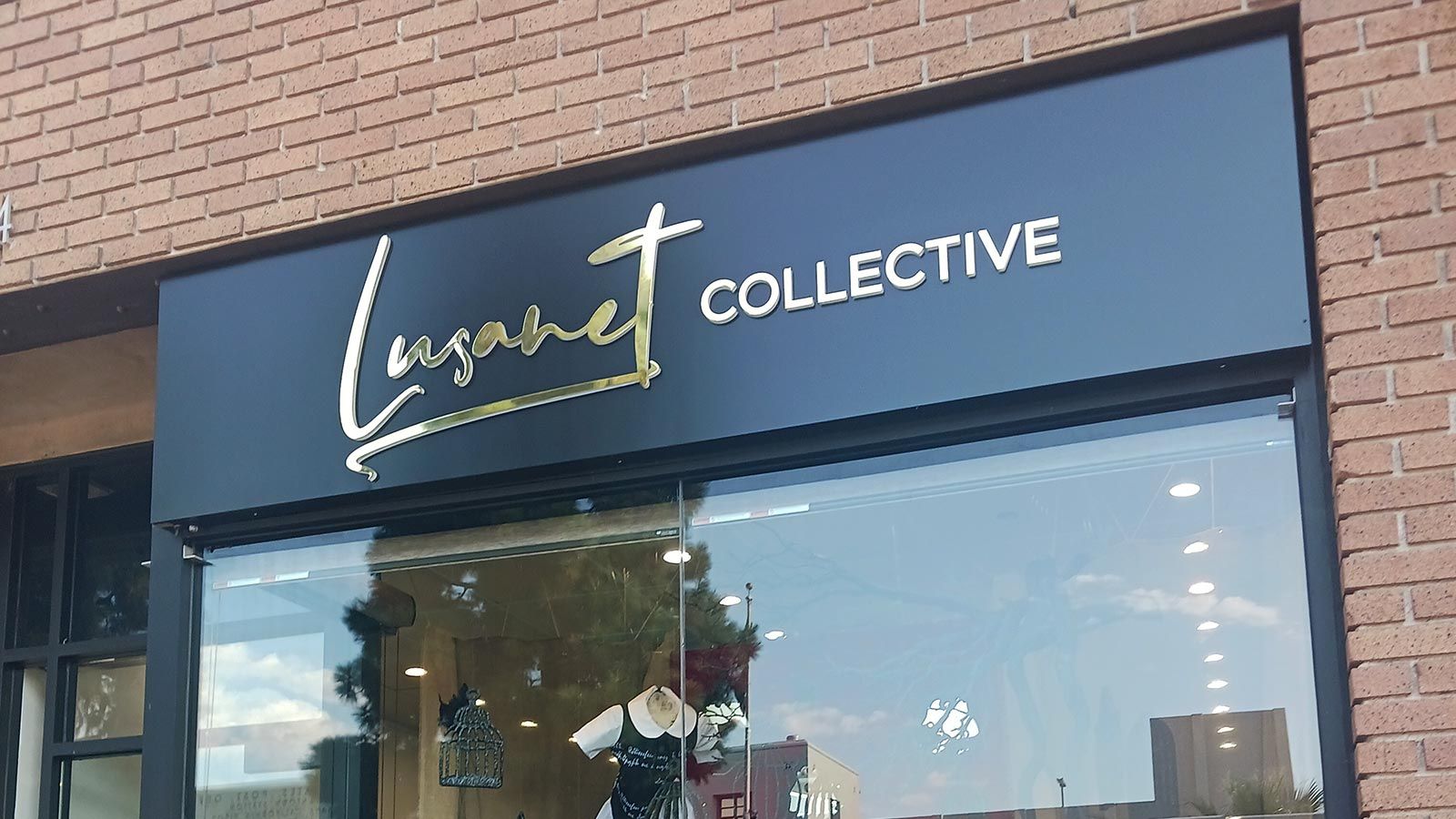 Lusanet Collective light up sign attached outdoors