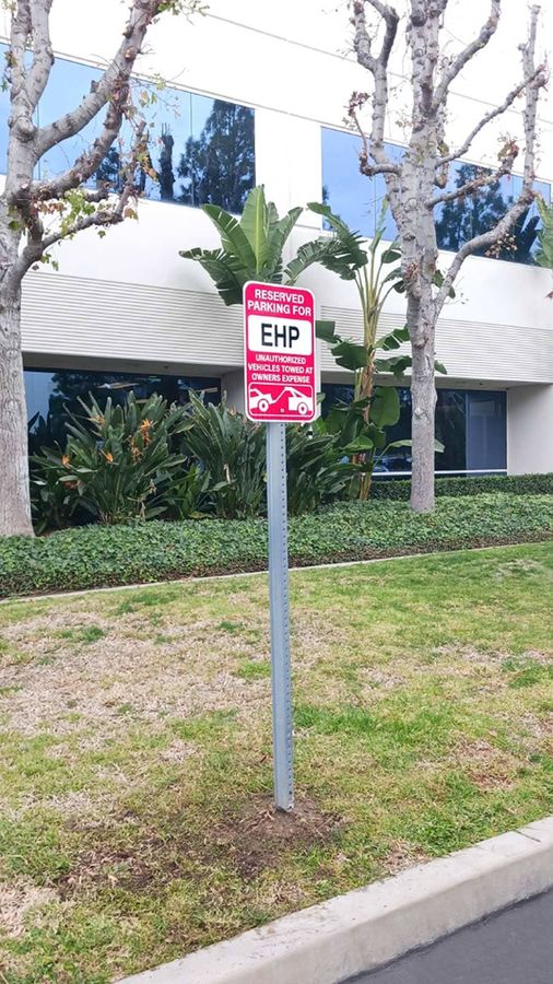 Regulatory sign installation for an outdoor parking lot