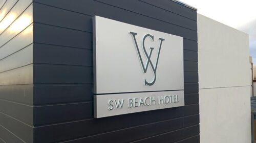 SW Beach Hotel push through sign set up on the wall