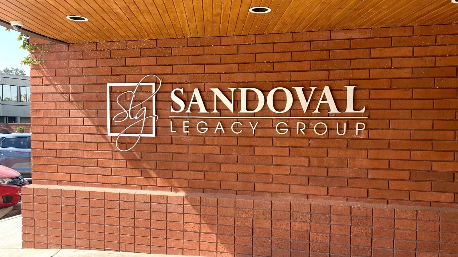 Sandoval Legacy Group aluminum sign mounted on the wall