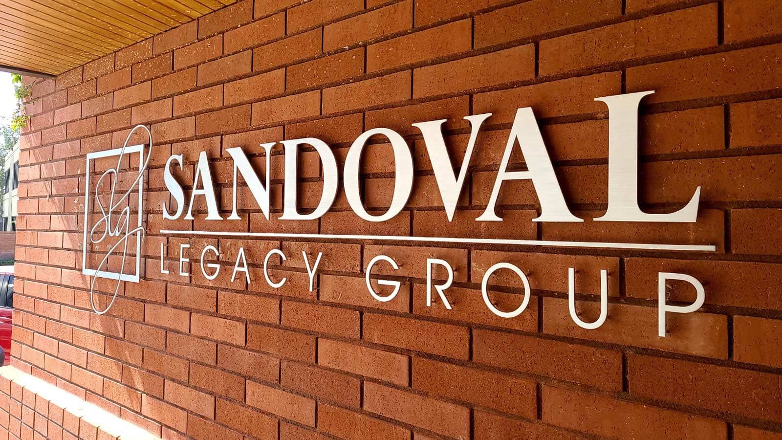 Sandoval Legacy Group logo sign attached to the wall