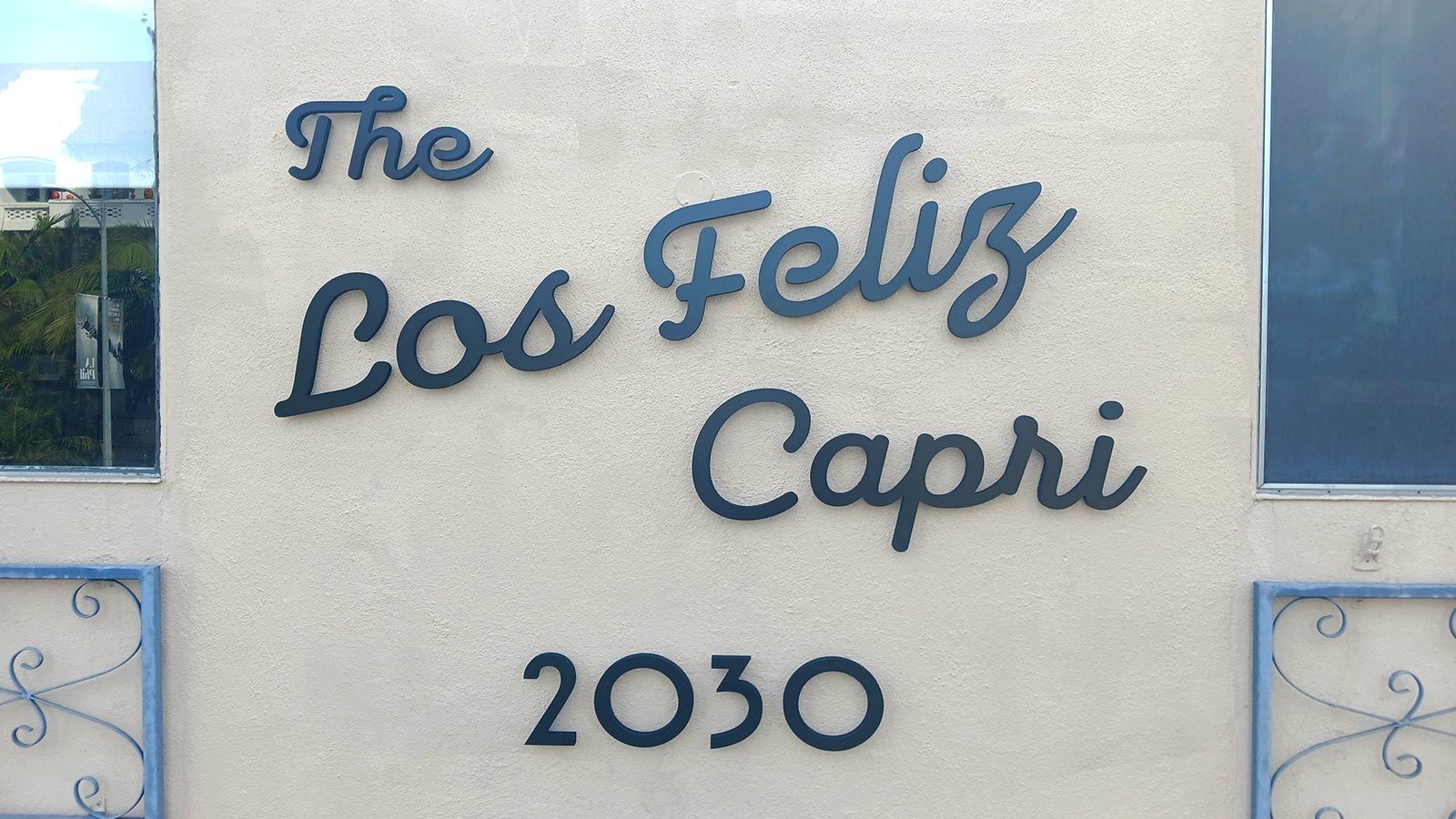 The Los Feliz Capri PVC sign attached to the exterior wall
