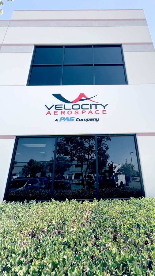 Velocity Aerospace 3D sign mounted on the exterior wall